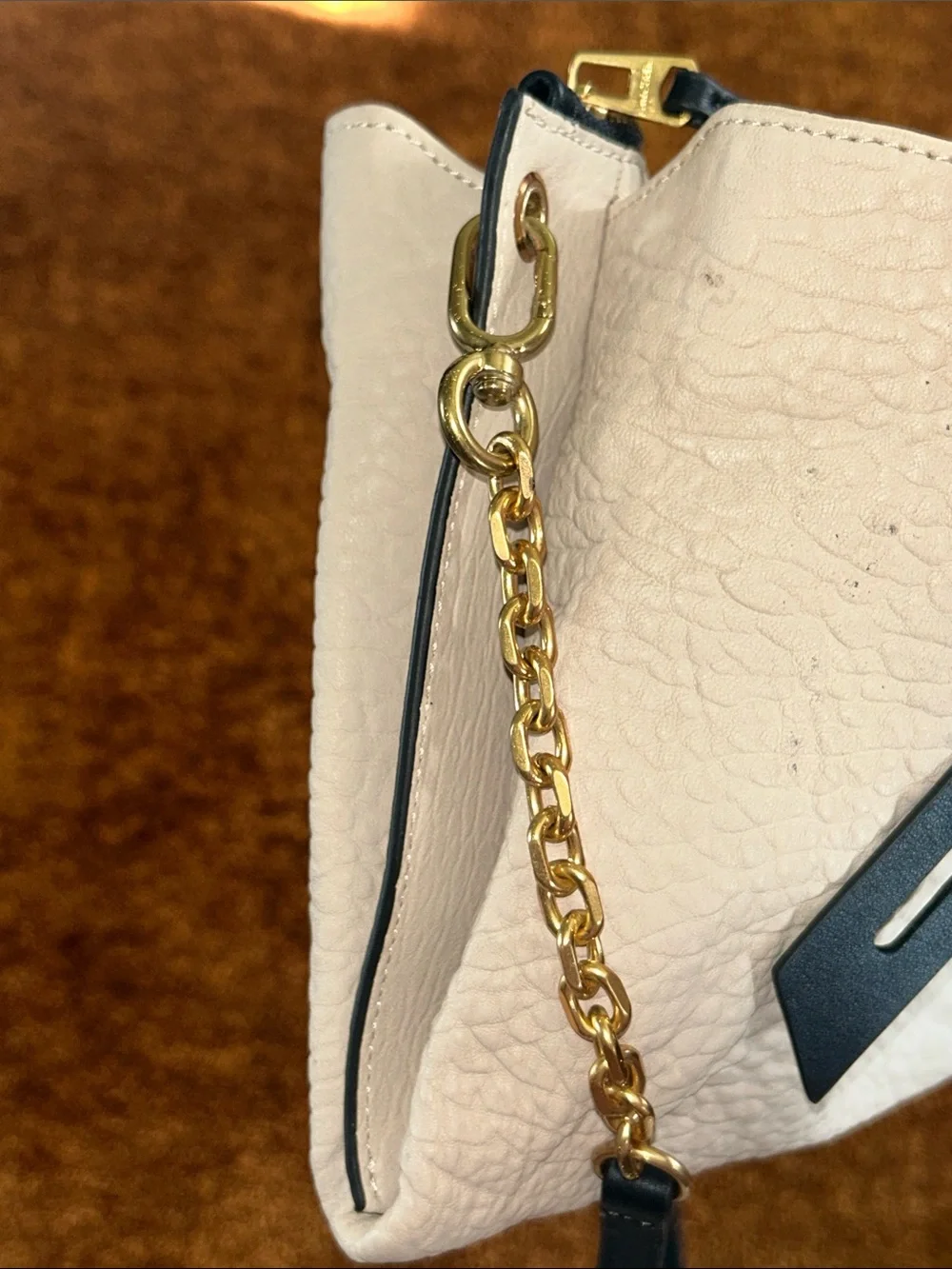 Cream Crossbody Bag with Black Strap and Gold Chain Accent